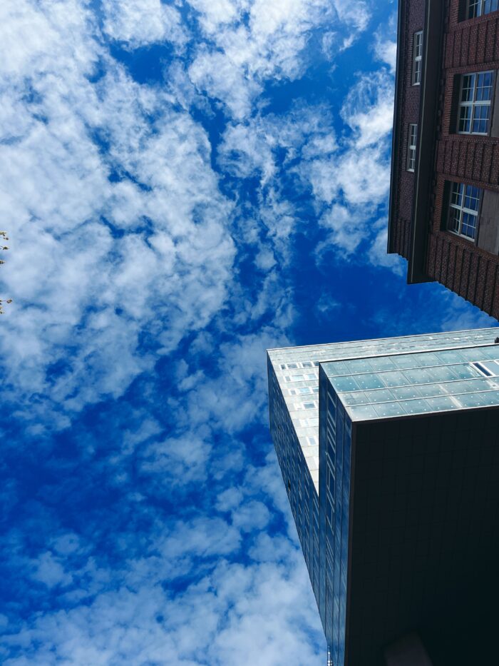Blauer Himmel über der Glasmetallfront eines Hochhauses in St. Georg