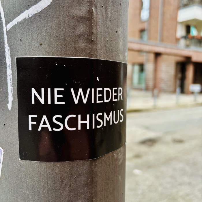 Ein Aufkleber an einem Ampelmast: Nie wieder Faschismus