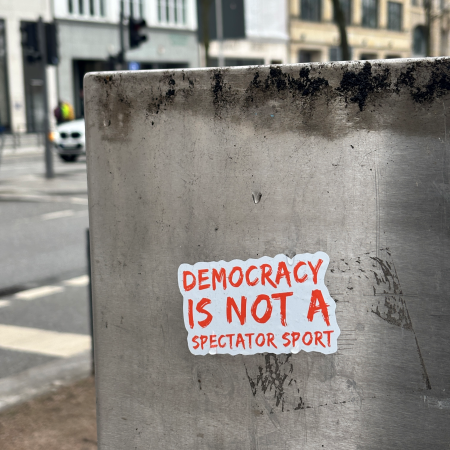 Ein Sticker: Democracy is not a spectator sport