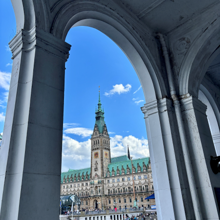 Blick durch die Bogenstruktur der Alsterarkaden zum Rathaus