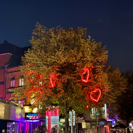 Neonleuchtherzen als Deko in einem Baum am Hamburger Berg